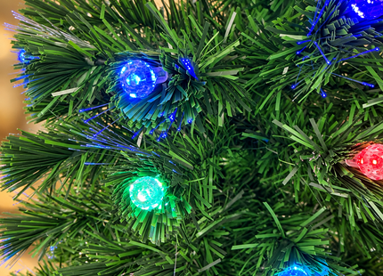 Close-up of green tree branches, fiber optic tips and multicolor light covers